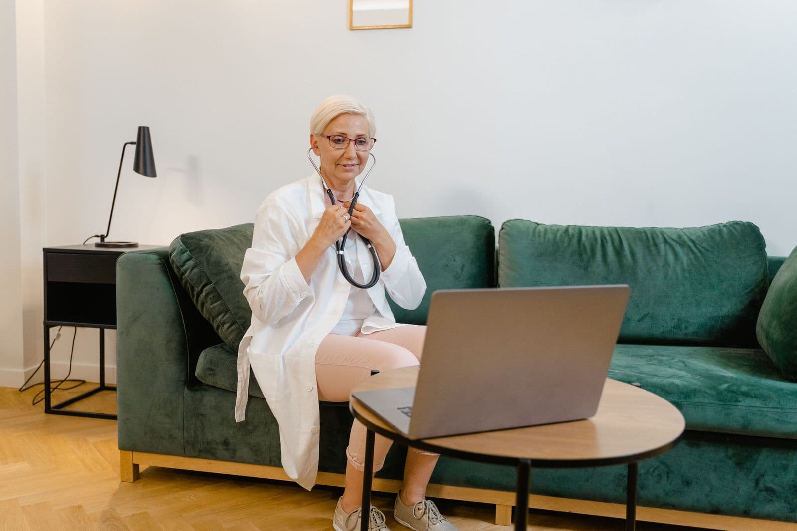 A clinician following up with a discharged patient over a video consultation