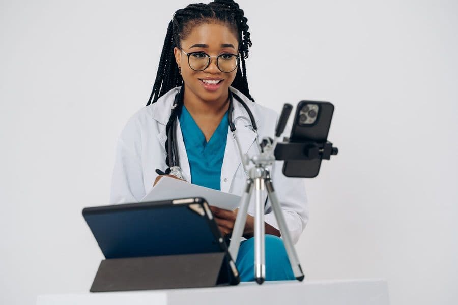 A physiotherapist smiling on the call, mid-assessment